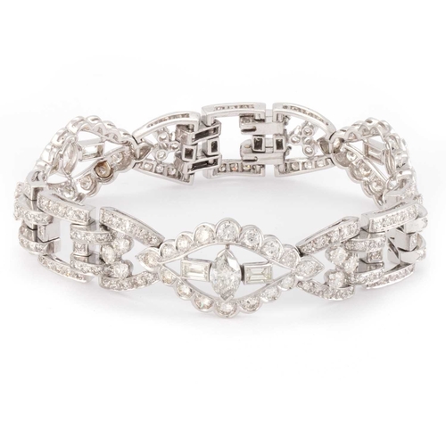 588 - AN ART DECO STYLE DIAMOND COCKTAIL BRACELET unmarked, having three navette shaped links, each set wi... 