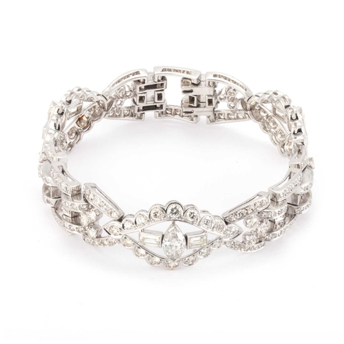 588 - AN ART DECO STYLE DIAMOND COCKTAIL BRACELET unmarked, having three navette shaped links, each set wi... 