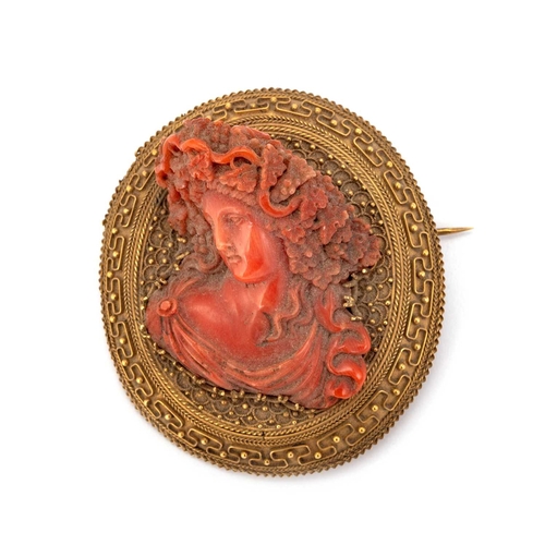 622 - A LARGE 19TH CENTURY CARVED CORAL BROOCH the coral carved in high relief depicting a bacchante, set ... 