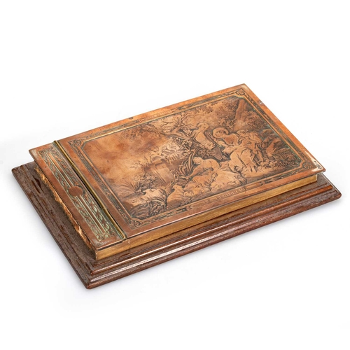 703A - A FRENCH COPPER AND MAHOGANY-MOUNTED NOTEBOOK, CIRCA 1900 the hinged cover is decorated in low relie... 