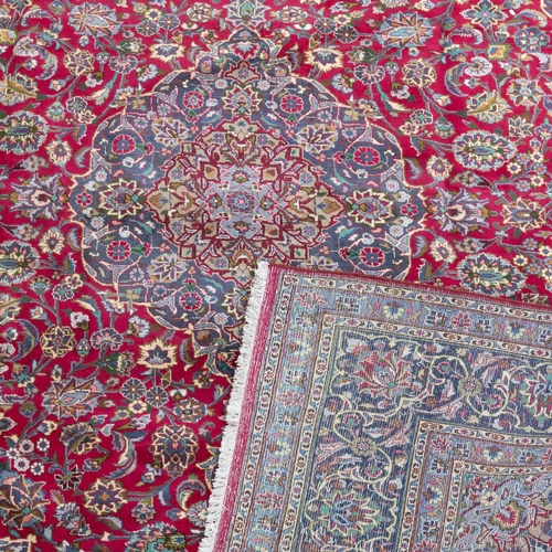 713 - A PERSIAN MASHAD CARPET 381cm by 289cm