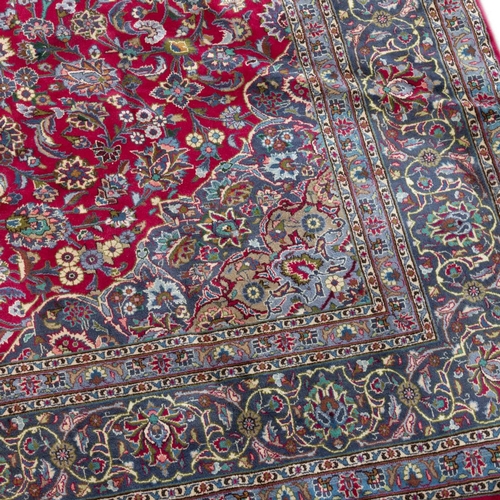 713 - A PERSIAN MASHAD CARPET 381cm by 289cm