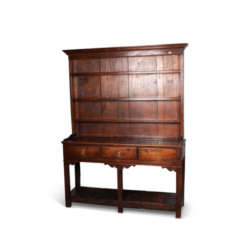 741 - AN 18TH CENTURY OAK DRESSER AND RACK the enclosed rack with a moulded cornice and three shelves, the... 