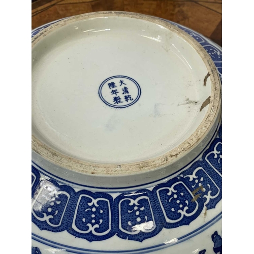 758 - A CHINESE CARVED AND RED LACQUERED ELM WASHSTAND WITH A CHINESE BLUE AND WHITE PORCELAIN BOWL the st... 