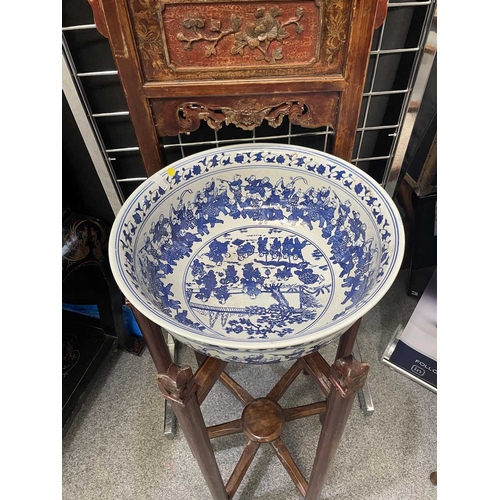 758 - A CHINESE CARVED AND RED LACQUERED ELM WASHSTAND WITH A CHINESE BLUE AND WHITE PORCELAIN BOWL the st... 