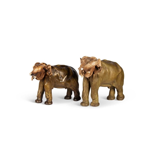 87 - A LARGE ROYAL DUX MODEL OF AN ELEPHANT, TOGETHER WITH ANOTHER LARGE ELEPHANT MODEL the first with ap... 