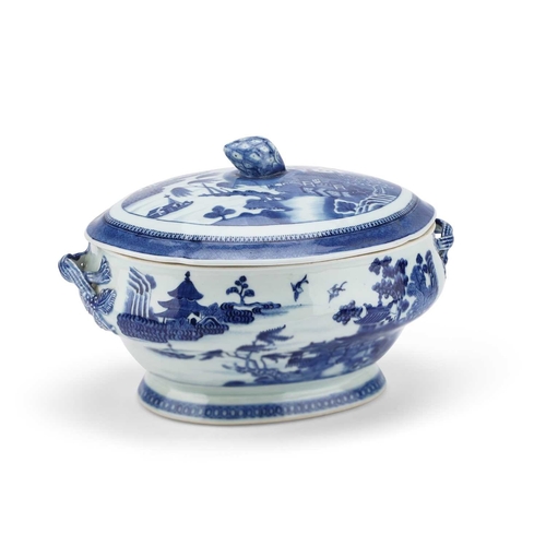 103 - A 19TH CENTURY NANKING BLUE AND WHITE TUREEN AND COVER the shaped oval cover with a pineapple finial... 