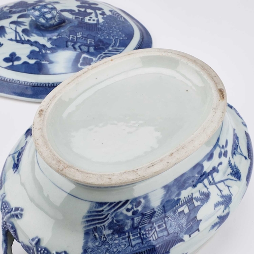 103 - A 19TH CENTURY NANKING BLUE AND WHITE TUREEN AND COVER the shaped oval cover with a pineapple finial... 