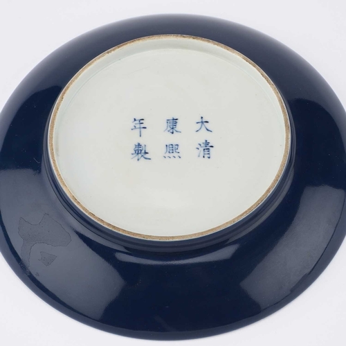 107 - A CHINESE BLUE AND WHITE 'DRAGON' DISH painted with a five-claw dragon above the waves and surrounde... 