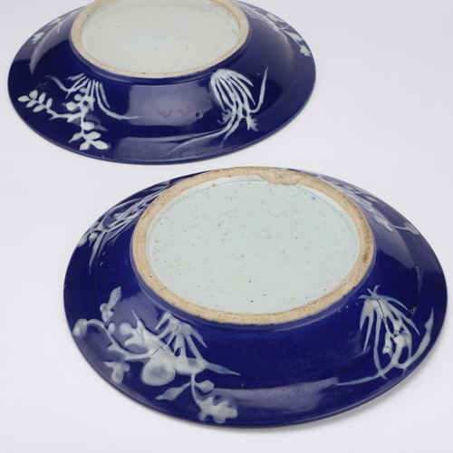 109 - A PAIR OF CHINESE REVERSE SLIP-DECORATED BLUE AND WHITE DISHES, PROBABLY 19TH CENTURY the wide rims ... 