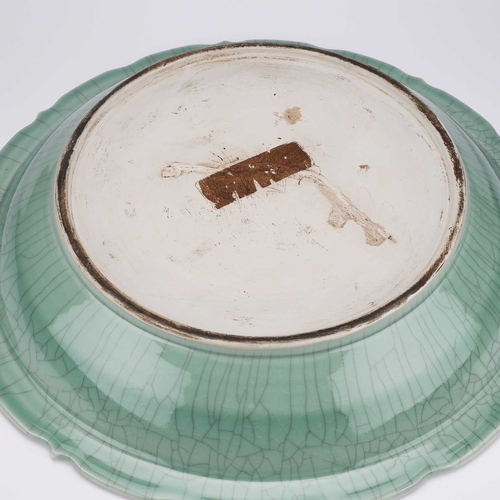 122 - A LARGE CHINESE CELADON 'DRAGON' DISH decorated in low relief with a dragon. 54cm diameterNo chips, ... 