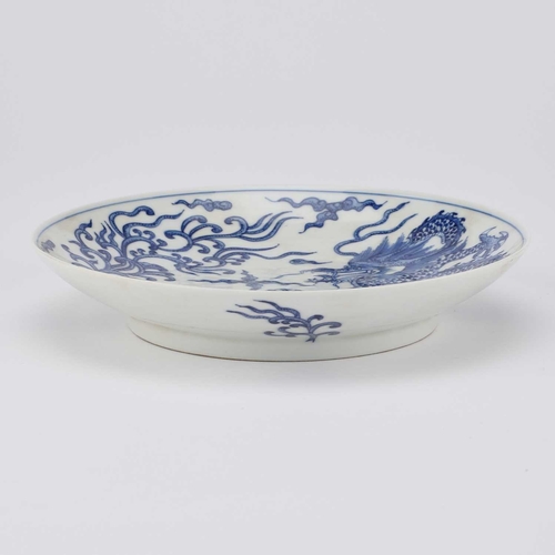 123 - A CHINESE BLUE AND WHITE 'DRAGON AND PHOENIX' DISH painted with a five-claw dragon and a phoenix sur... 