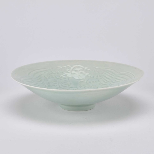 138 - A CHINESE CELADON CONICAL BOWL incised with three figures and foliage. 20.5cm diameterThere is a hai... 