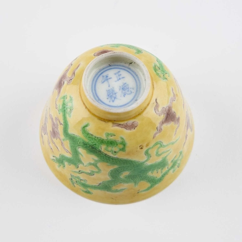 142 - A CHINESE YELLOW-GROUND 'DRAGON' CUP painted in green enamels with two dragons, bears a four-charact... 