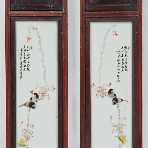 143 - A PAIR OF CHINESE PORCELAIN PANELS each decorated in a Famille Rose palette with birds perched on a ... 