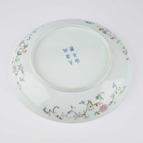 150 - A CHINESE FAMILLE ROSE DISH brightly decorated in the interior with a lime-green lotus scroll medall... 