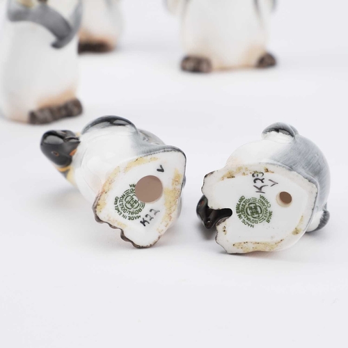 63 - A SET OF SIX ROYAL DOULTON PENGUINS including the rare K24 model with an outstretched wing. (6) Tall... 