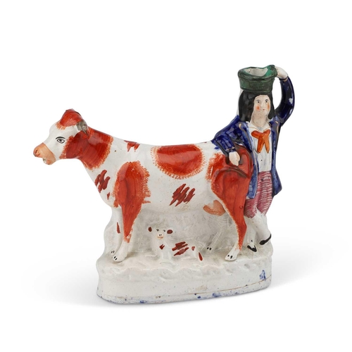 107 - A 19TH CENTURY STAFFORDSHIRE COW CREAMER modelled as a cow with a calf laying below, a figure leant ... 