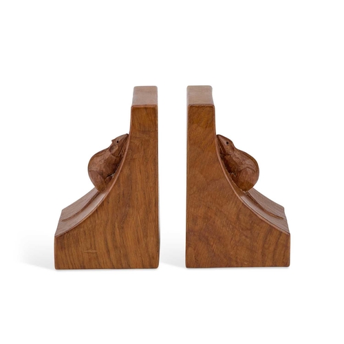 1186 - ROBERT THOMPSON OF KILBURN: A PAIR OF MOUSEMAN OAK BOOKENDS of typical convex form, each with a carv... 