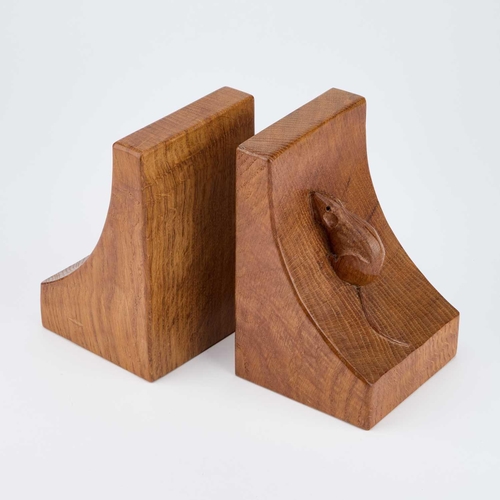 1186 - ROBERT THOMPSON OF KILBURN: A PAIR OF MOUSEMAN OAK BOOKENDS of typical convex form, each with a carv... 