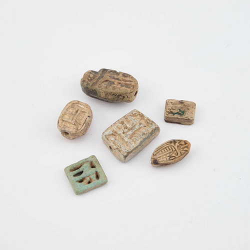 15 - SIX ANCIENT EGYPT AMULETS, LATE PERIOD including scarabs and plaques. (6)
 