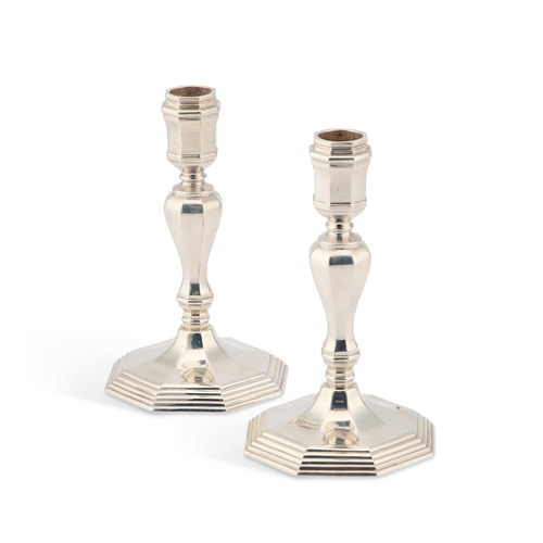 307 - A PAIR OF ELIZABETH II CAST SILVER CANDLESTICKS maker F.G, London 1963, each with faceted baluster s... 