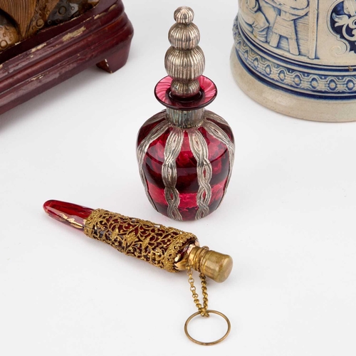 328 - A SILVER-OVERLAID RUBY GLASS SCENT BOTTLE together with a gilt-metal mounted cranberry glass scent f... 