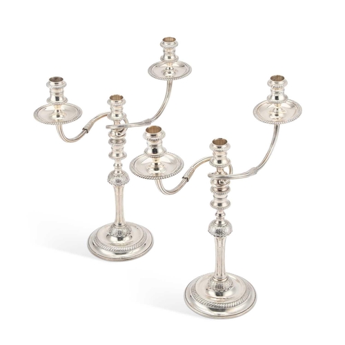 331 - A PAIR OF GEORGIAN STYLE CAST SILVER THREE-LIGHT CANDELABRA by Garrard & Co Ltd, London 1969, ea... 