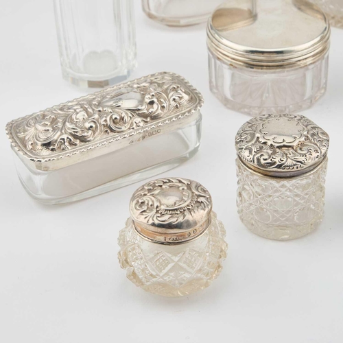 398 - A COLLECTION OF SILVER-TOPPED GLASS JARS various marks. (14) Tallest 10.5cm high