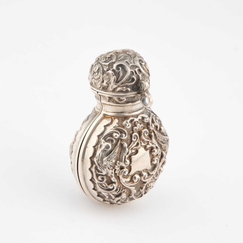 401 - A GEORGE V SILVER AND GREEN GLASS SCENT BOTTLE by John & William F Deakin, London 1910, the hing... 