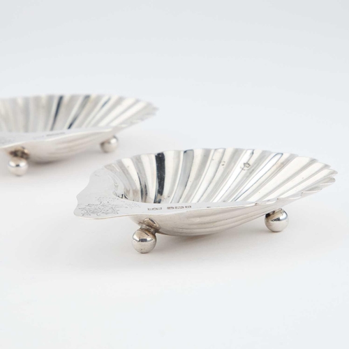 411 - A PAIR OF EDWARDIAN SILVER SHELL-SHAPED BUTTER DISHES by Mappin & Webb Ltd, Sheffield 1905, each... 