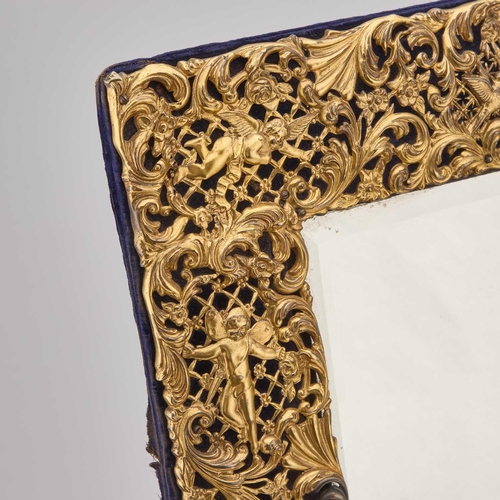 467 - A LARGE VICTORIAN SILVER-GILT DRESSING TABLE MIRROR by Charles Henry Dumenil, London 1899, of shaped... 