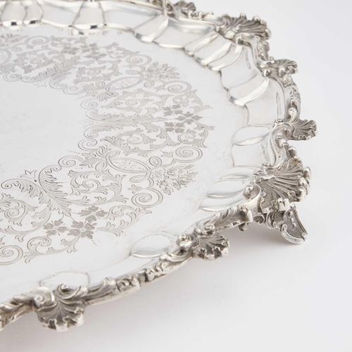 475 - A LARGE VICTORIAN SILVER SALVER by Charles Boyton (II), London 1886, shaped circular, the rim decora... 