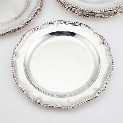 528 - A SET OF TWENTY-FOUR GEORGE III SILVER DINNER PLATES probably by John King, London 1764, cusped circ... 