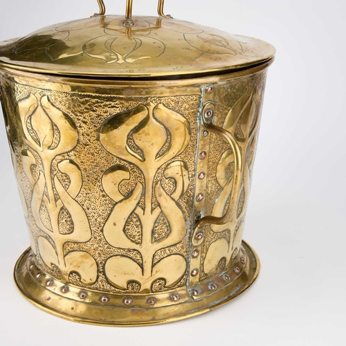 545 - AN ARTS AND CRAFTS BRASS COAL BIN the domed lid with a tri-form handle, the base with slightly taper... 