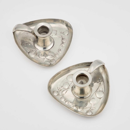 582 - ARCHIBALD KNOX (1864-1933) FOR LIBERTY & CO, A PAIR OF TUDRIC PEWTER CHAMBERSTICKS triangular sectio... 