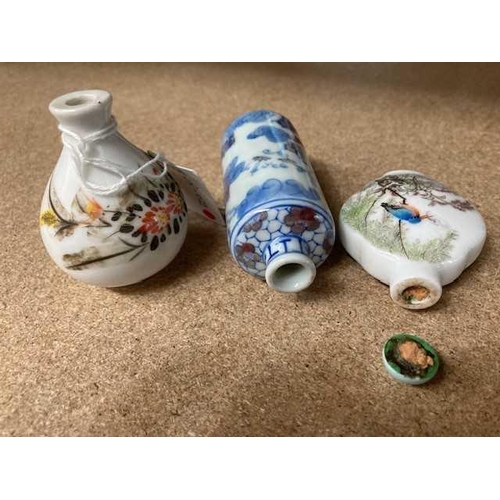 601 - THREE CHINESE PORCELAIN SNUFF BOTTLES including an underglaze blue and copper red cylindrical bottle... 