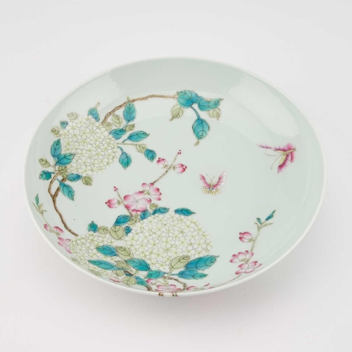 605 - A CHINESE FAMILLE ROSE DISH circular with rounded sides, enamel painted with butterflies and flowers... 