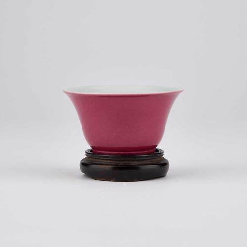 614 - A CHINESE RUBY-GROUND 'BUTTERFLY' CUP the exterior with a monochrome ruby glaze, the interior enamel... 