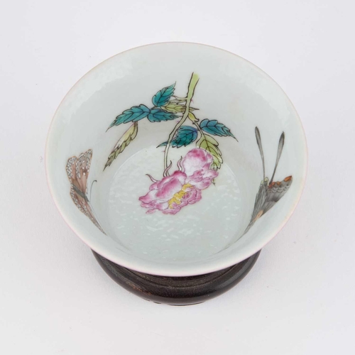 614 - A CHINESE RUBY-GROUND 'BUTTERFLY' CUP the exterior with a monochrome ruby glaze, the interior enamel... 