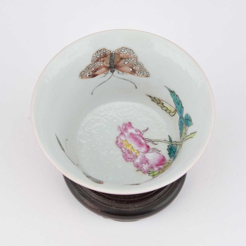 614 - A CHINESE RUBY-GROUND 'BUTTERFLY' CUP the exterior with a monochrome ruby glaze, the interior enamel... 