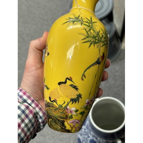 624 - A CHINESE FAMILLE ROSE GINGER JAR painted with flowers and rockwork; together with a Chinese yellow ... 