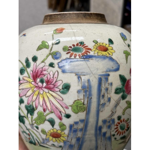 624 - A CHINESE FAMILLE ROSE GINGER JAR painted with flowers and rockwork; together with a Chinese yellow ... 