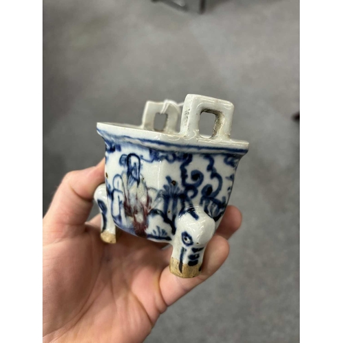 642 - A CHINESE HEXAGONAL TRIPOD CENSER painted in underglaze blue and red with immortals. 9cm high, 8cm w... 