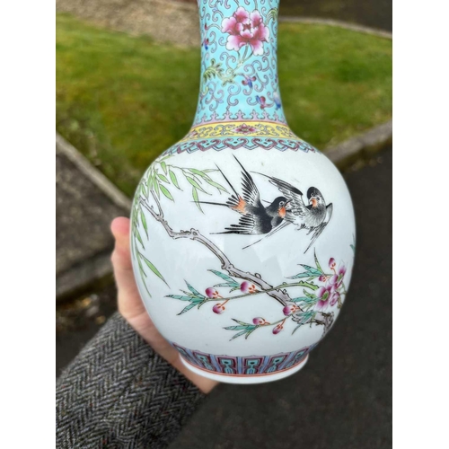 655 - A CHINESE FAMILLE ROSE VASE the ovoid body painted with two birds and prunus blossom, bears an iron-... 