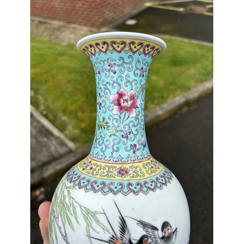 655 - A CHINESE FAMILLE ROSE VASE the ovoid body painted with two birds and prunus blossom, bears an iron-... 