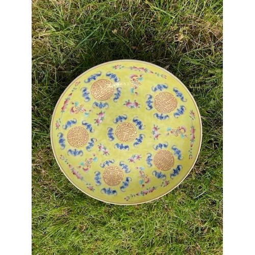 657 - A CHINESE FAMILLE ROSE YELLOW-GROUND DISH circular with rounded sides, decorated with six 'shou' med... 