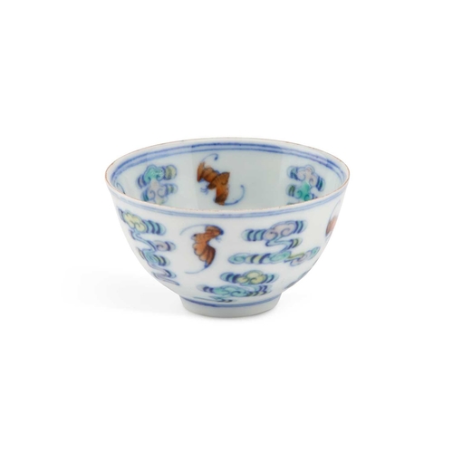 658 - A CHINESE DOUCAI TEA BOWL circular with rounded sides, decorated with bats and clouds, bears a six-c... 