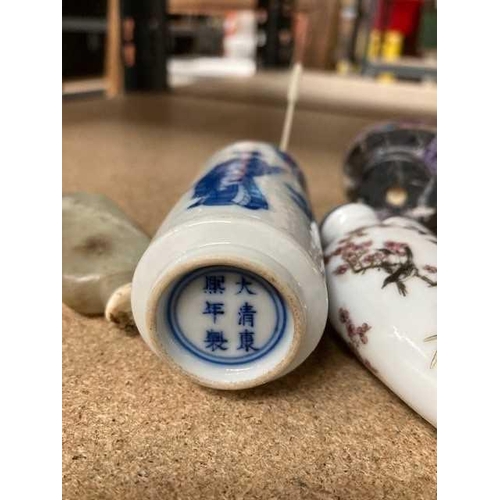 676 - FOUR CHINESE SNUFF BOTTLES including a blue and white figural cylindrical bottle. (4) Blue and white... 