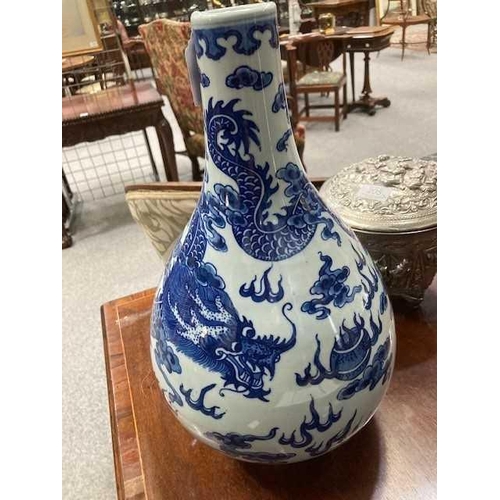 689 - A LARGE CHINESE BLUE AND WHITE DRAGON BOTTLE VASE, QING DYNASTY boldly painted in vivid cobalt blue ... 